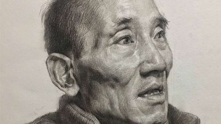 Drawing a portrait of man with charcoal pencil