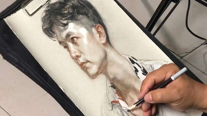 Drawing a portrait with color pencil by artist