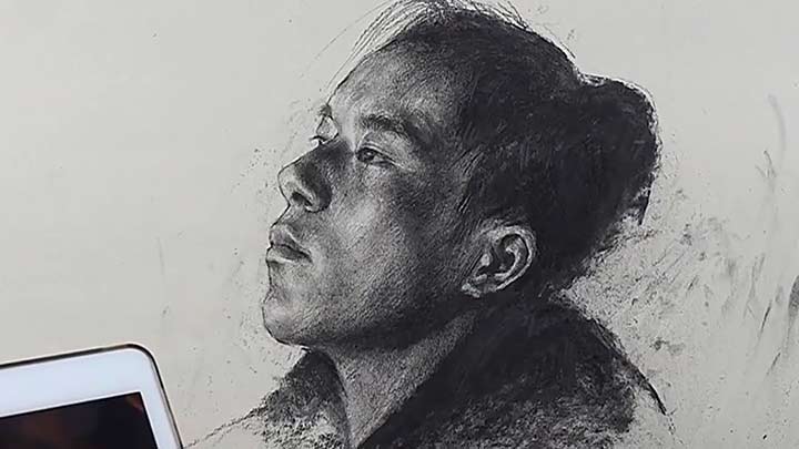 Young man portrait drawing with charcoal